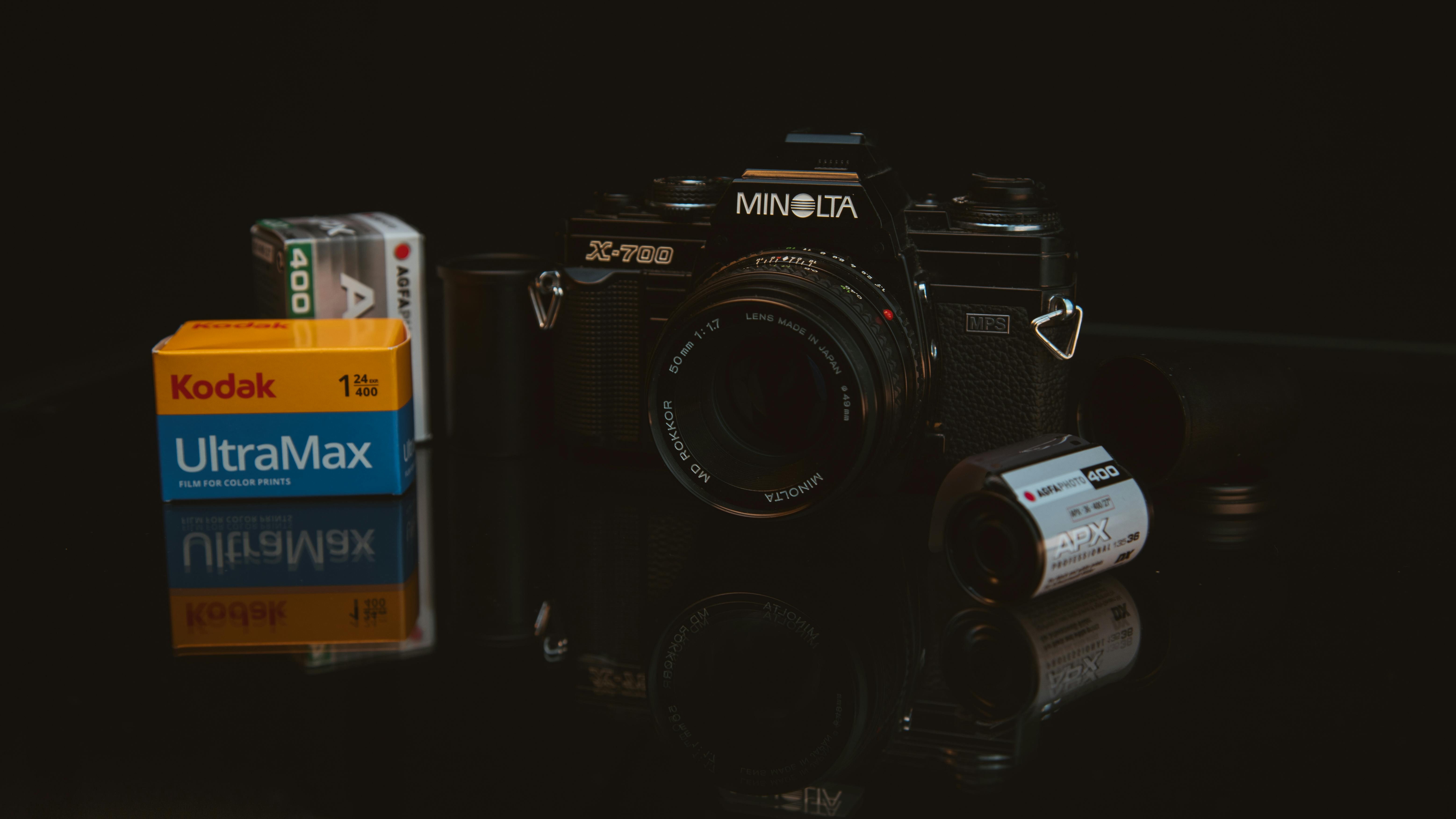 Classic Minolta X-700 SLR camera with Kodak UltraMax and AGFA film rolls.