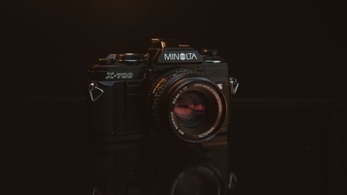 Free Close-up of a classic Minolta X-700 SLR film camera on a dark background. Stock Photo