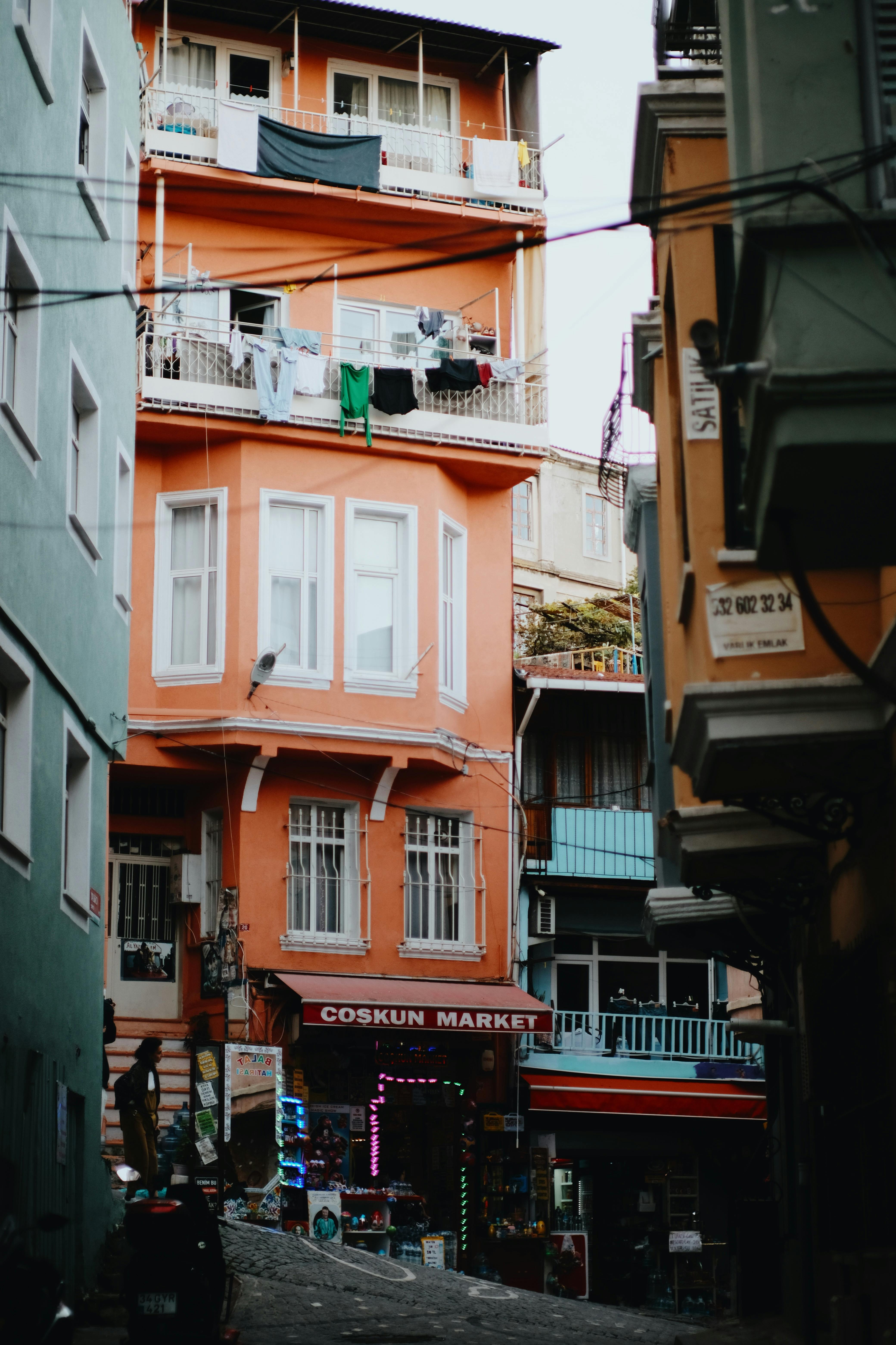 Vibrant street view featuring colorful buildings and a local market in an urban setting.