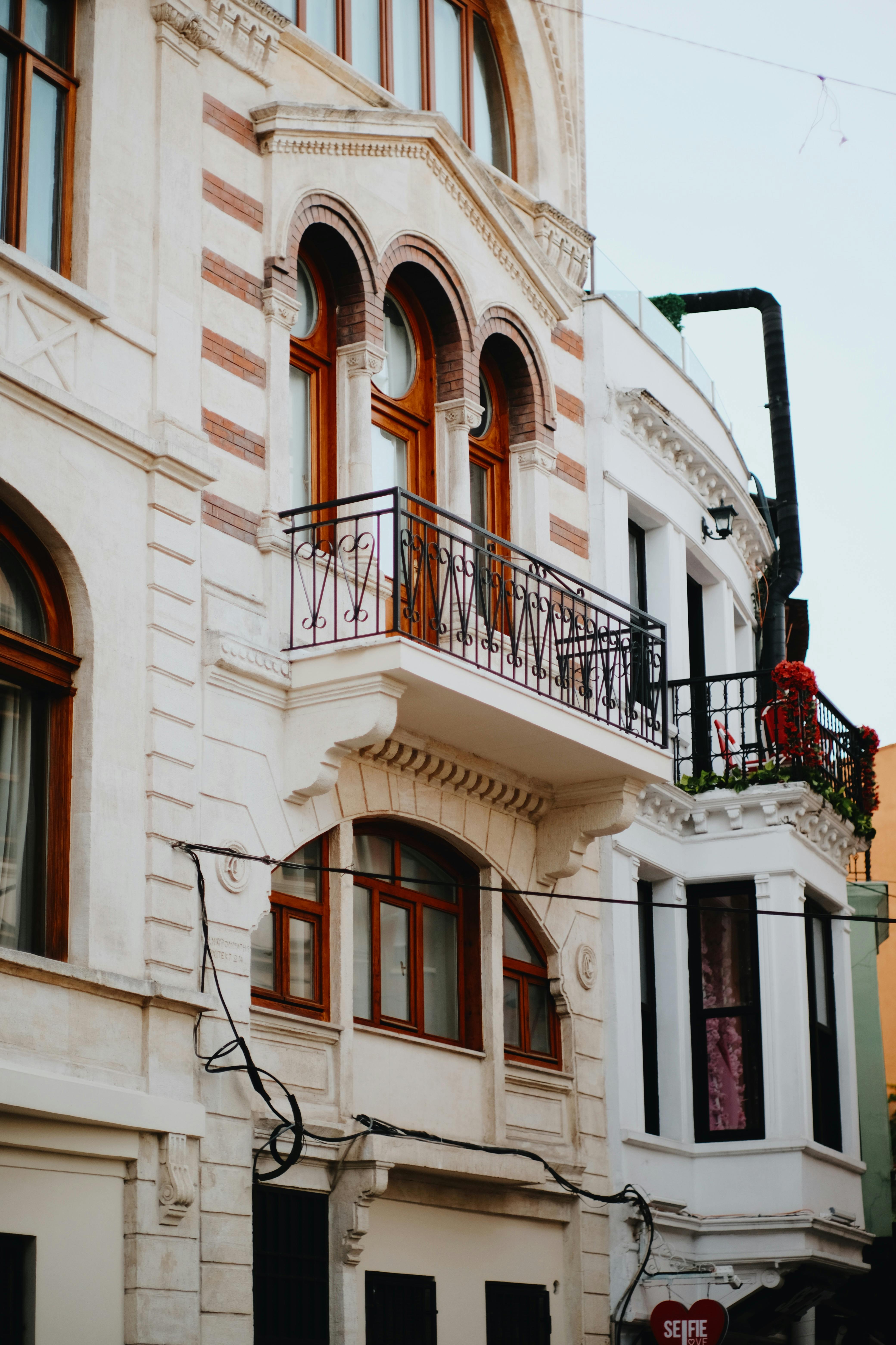 Detailed view of classic European architectural facade with ornate balconies and windows.