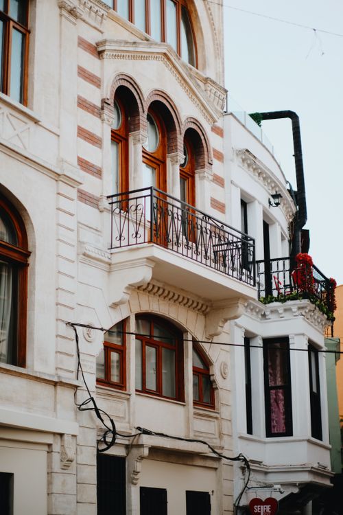 Free Detailed view of classic European architectural facade with ornate balconies and windows. Stock Photo