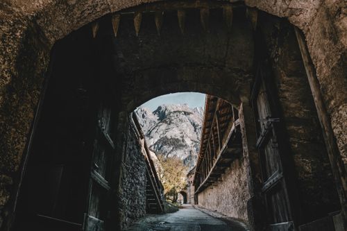 Free Explore a medieval stone archway leading to a breathtaking mountain view. Stock Photo