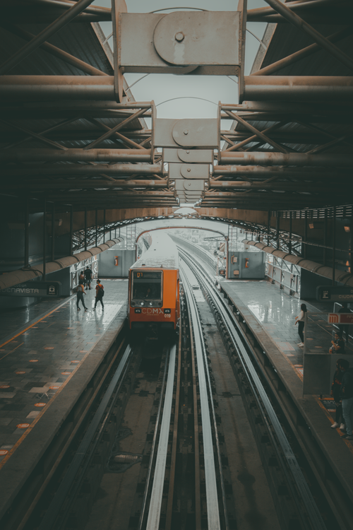 Free A yellow train arrives at a modern urban station, capturing the essence of city travel. Stock Photo