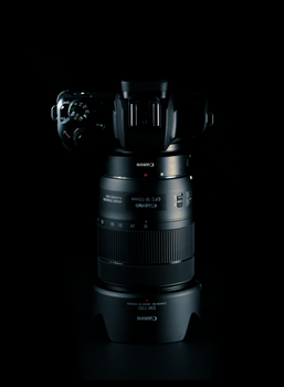 High-quality image of a camera lens on a dark background, showcasing precision engineering.