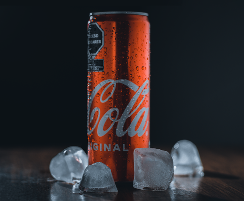 Free Chilled red soda can surrounded by ice cubes, condensation visible. Stock Photo