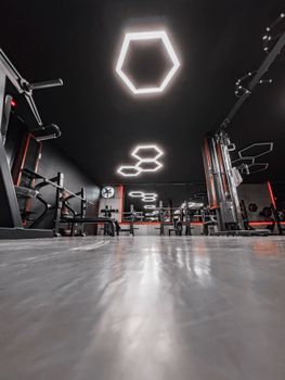 Sleek gym interior highlighting geometric ceiling lights and equipment.