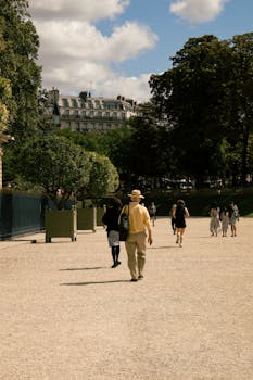 People walking in a sunny Paris park, capturing urban charm and leisure.