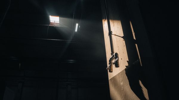 Dramatic light falling across industrial pipework — photo by Cemrecan Yurtman on Pexels