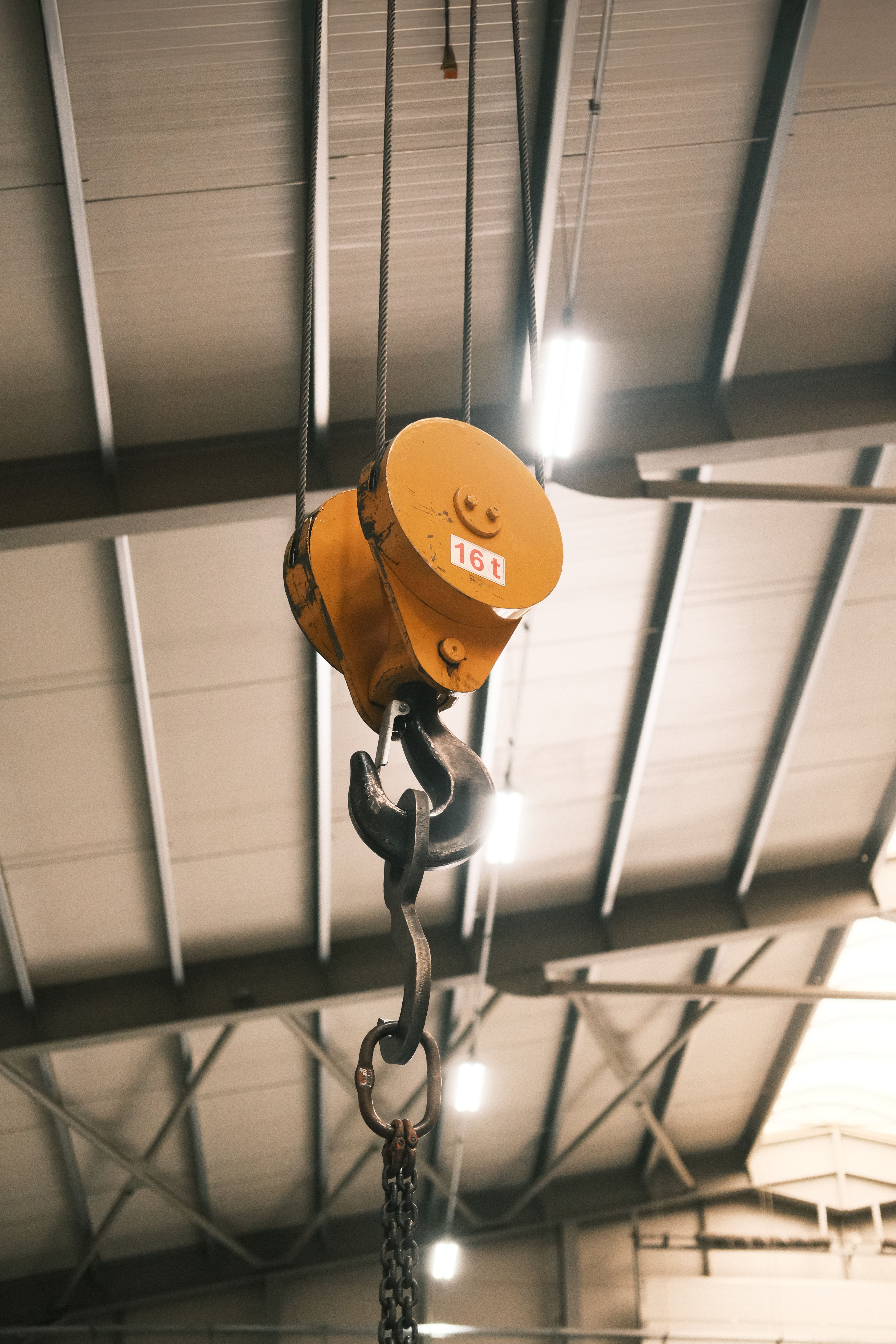 Crane hook and block hanging in a steel-framed bay