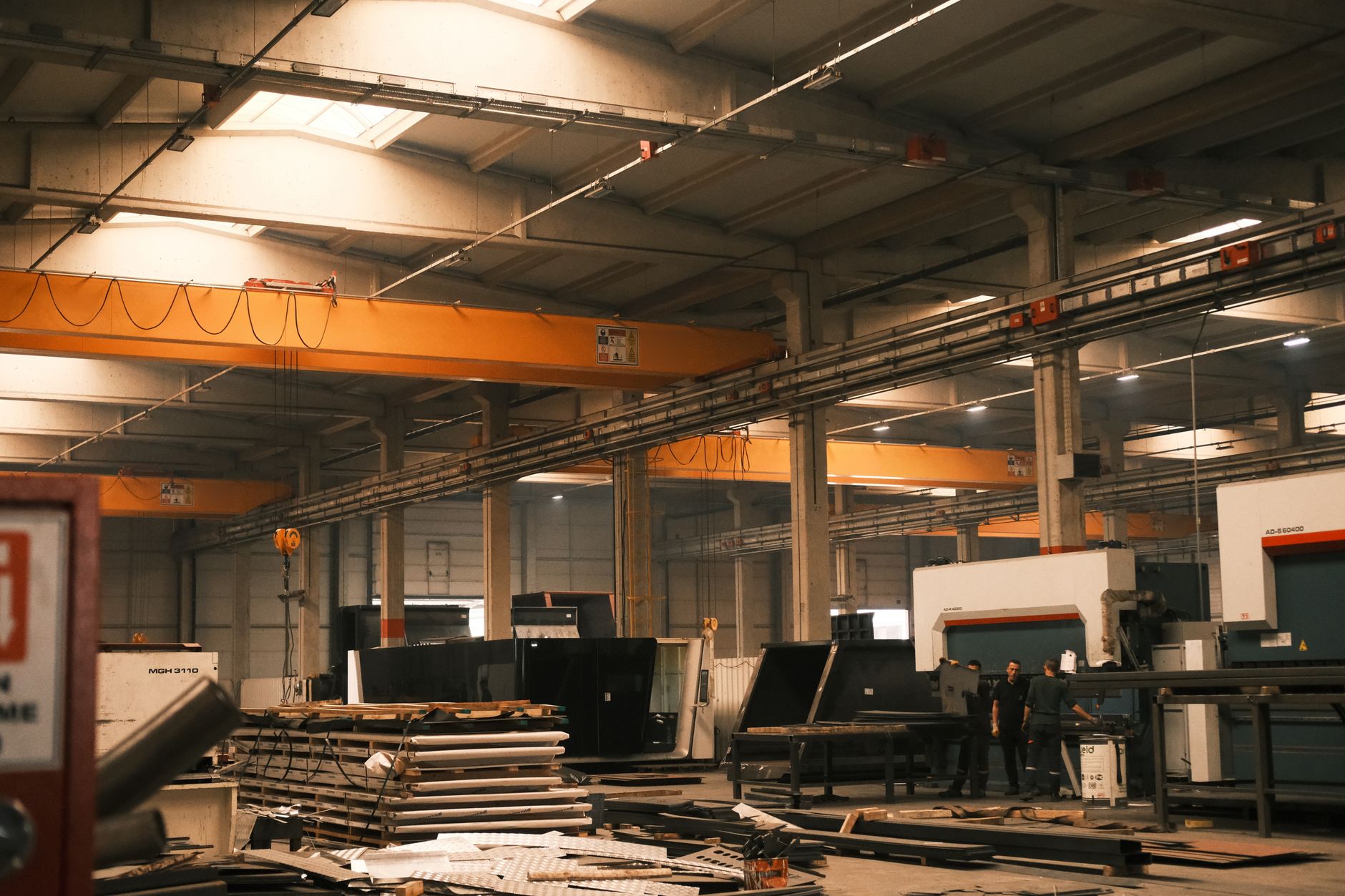 Interior view of an industrial warehouse with machinery and overhead cranes in Konya, Türkiye.