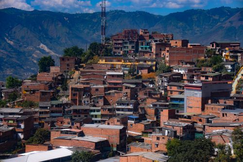 Free Colorful hillside neighborhood against scenic mountains in Medellin, Colombia. Stock Photo