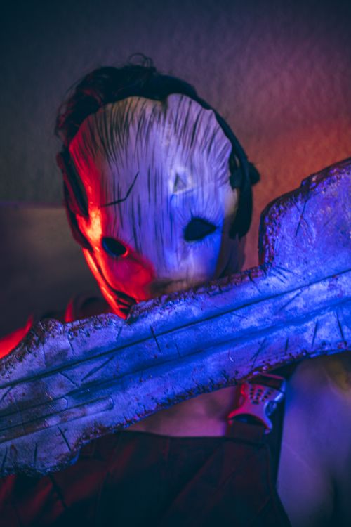 Free Close-up of a person in a scary Halloween mask, vibrant lighting. Stock Photo
