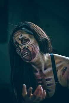 Detailed zombie makeup on a woman for a Halloween theme.