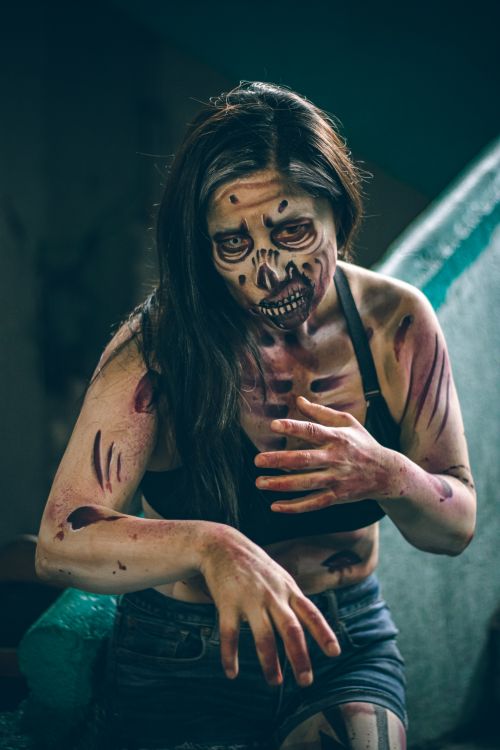 Free Frightening zombie-themed cosplay with detailed artistic makeup, perfect for Halloween inspiration. Stock Photo