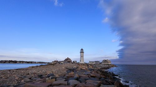 Free Stunning view of Scituate Lighthouse with dramatic ocean and sky backdrop. Stock Photo