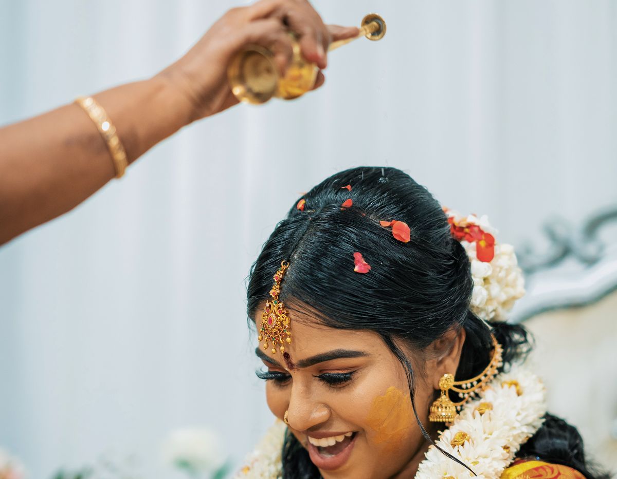 Bride at a pre-wedding ritual with flowers and turmeric