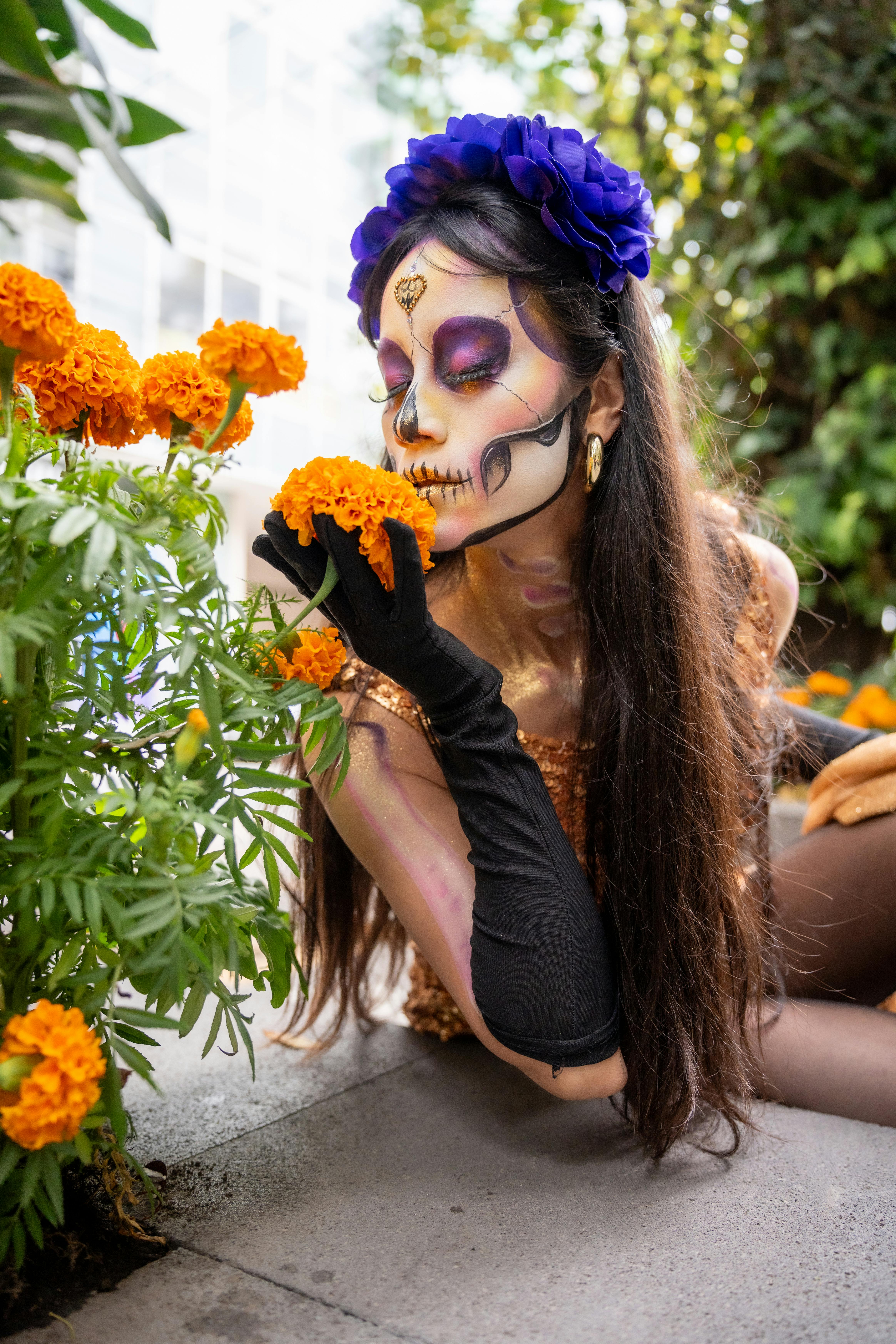 dia de muertos catrina admiring marigolds outdoors
