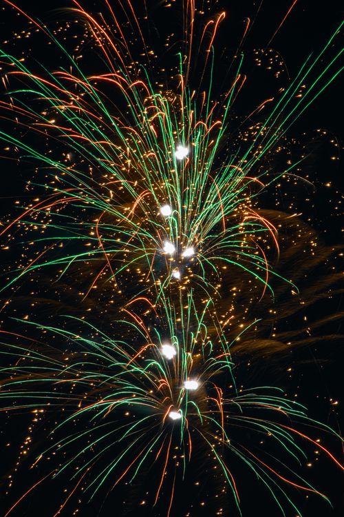 Free Colorful fireworks explode in the night sky, creating a festive and celebratory scene. Stock Photo