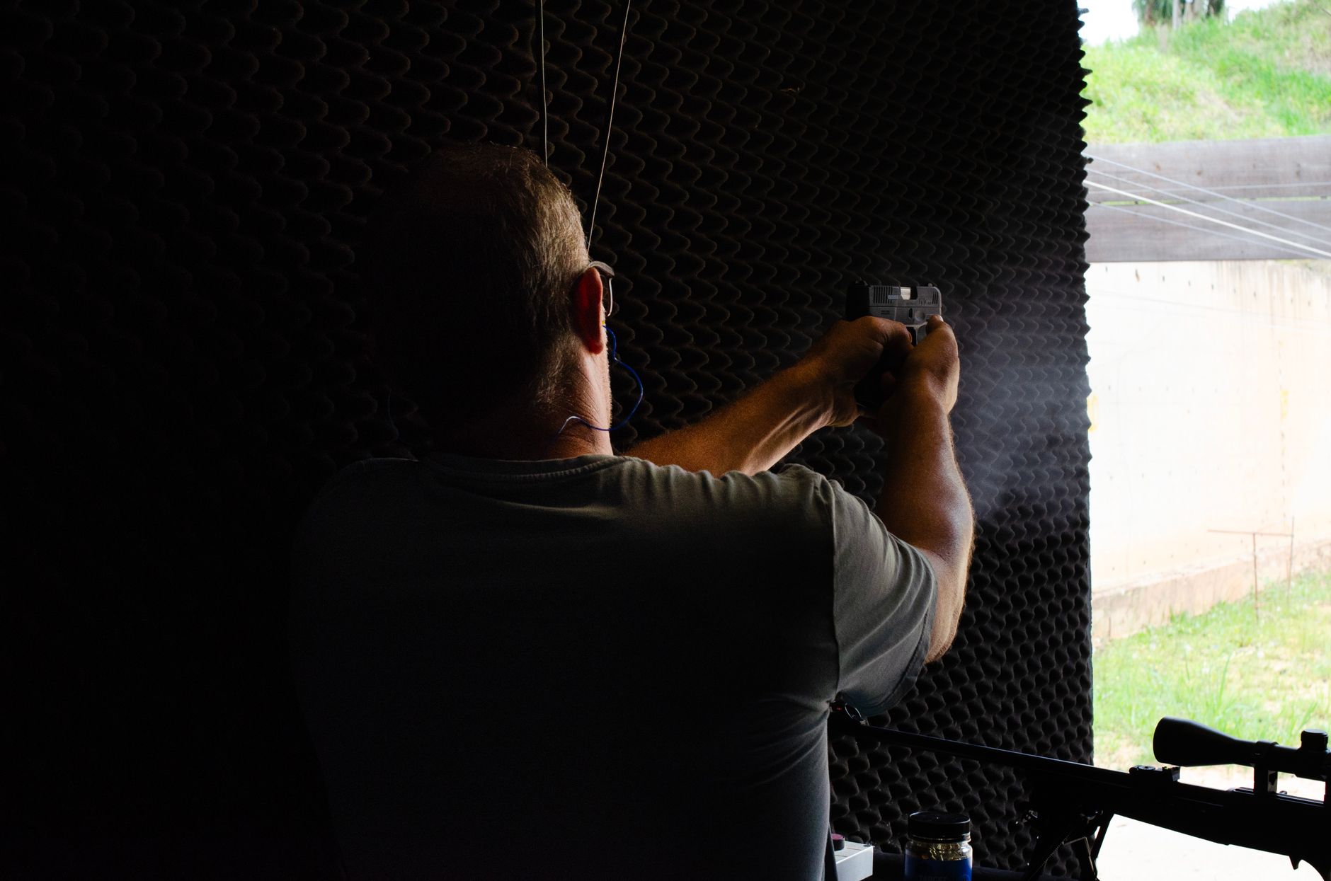 A man practicing shooting at an indoor gun range in São Paulo, Brasil.