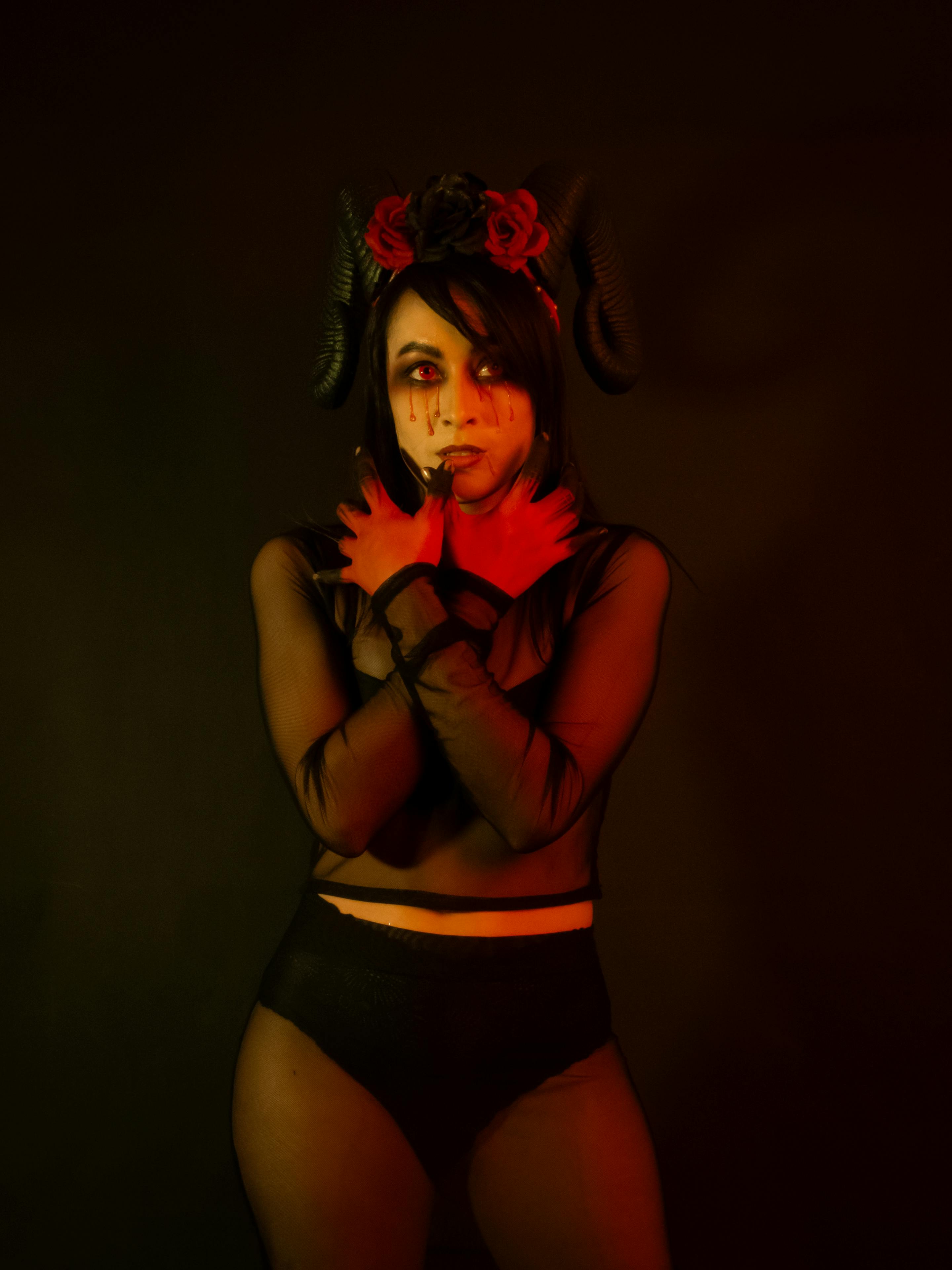 Gratuit Un portrait envoûtant d'une femme dans un costume de diable sombre et mystérieux. Photos