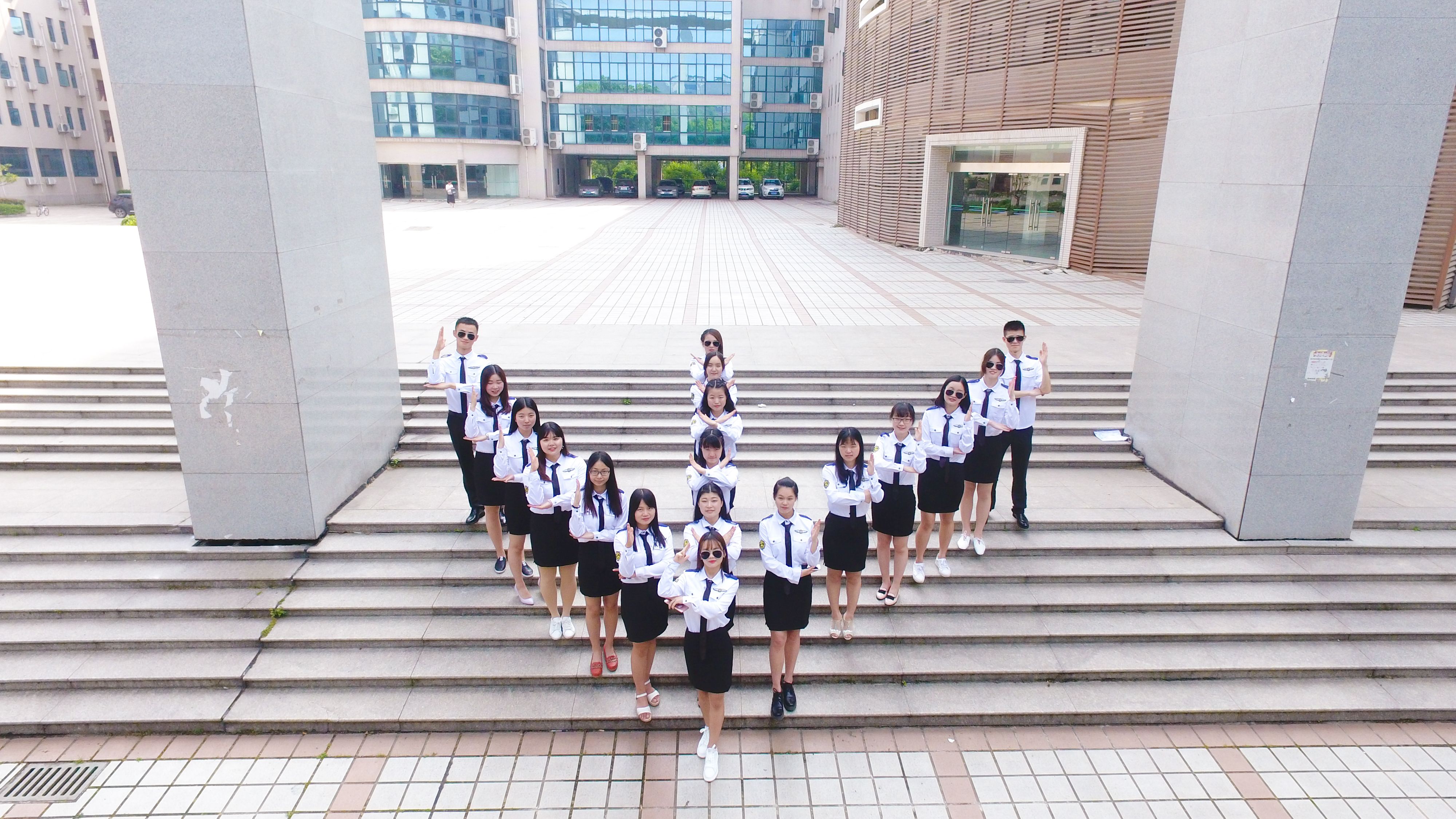 University Students Pose in Formation Outdoors · Free Stock Photo