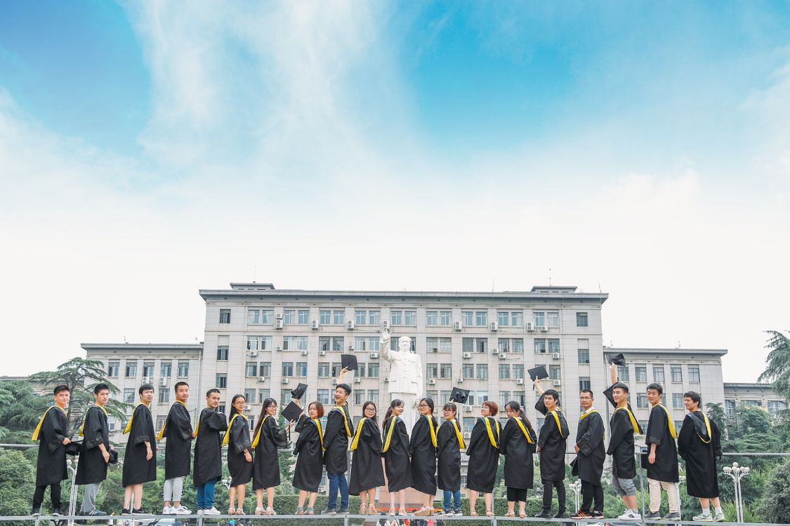 University graduation ceremony outdoors with students in academic robes