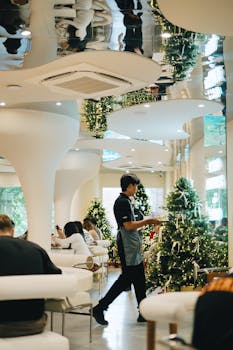 Modern cafe interior during Christmas with festive decorations and customers dining.