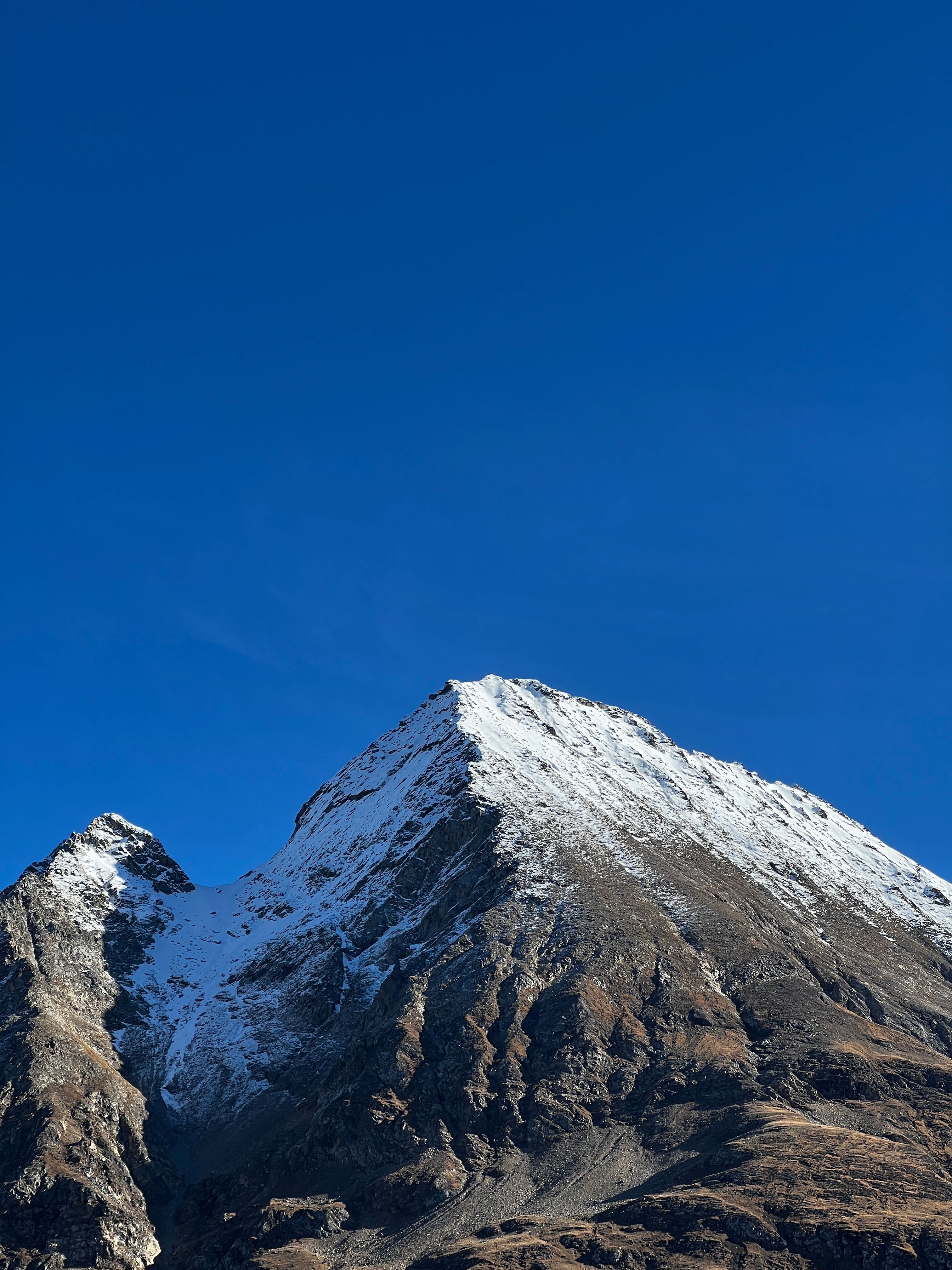 Snow-Covered Mountain Peak Under Clear Blue Sky · Free Stock Photo