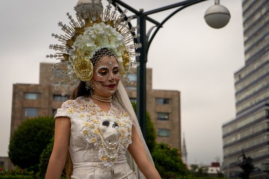 A woman dressed in Catrina makeup and costume, showcasing Mexican culture in Mexico City.