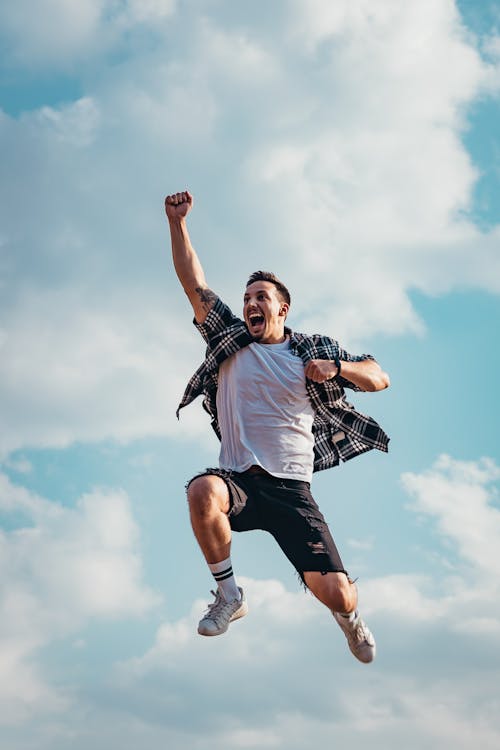 Free Low Angle Photography of Man Jumping Stock Photo