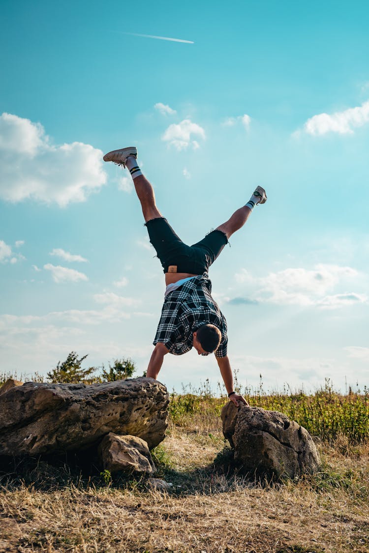 Man Balancing On Stones