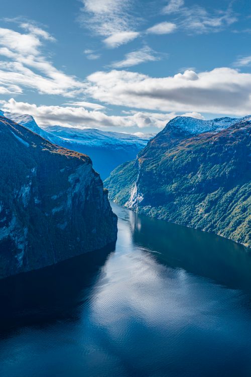 Free Stunning aerial photo of a Norwegian fjord with snow-capped mountains. Stock Photo