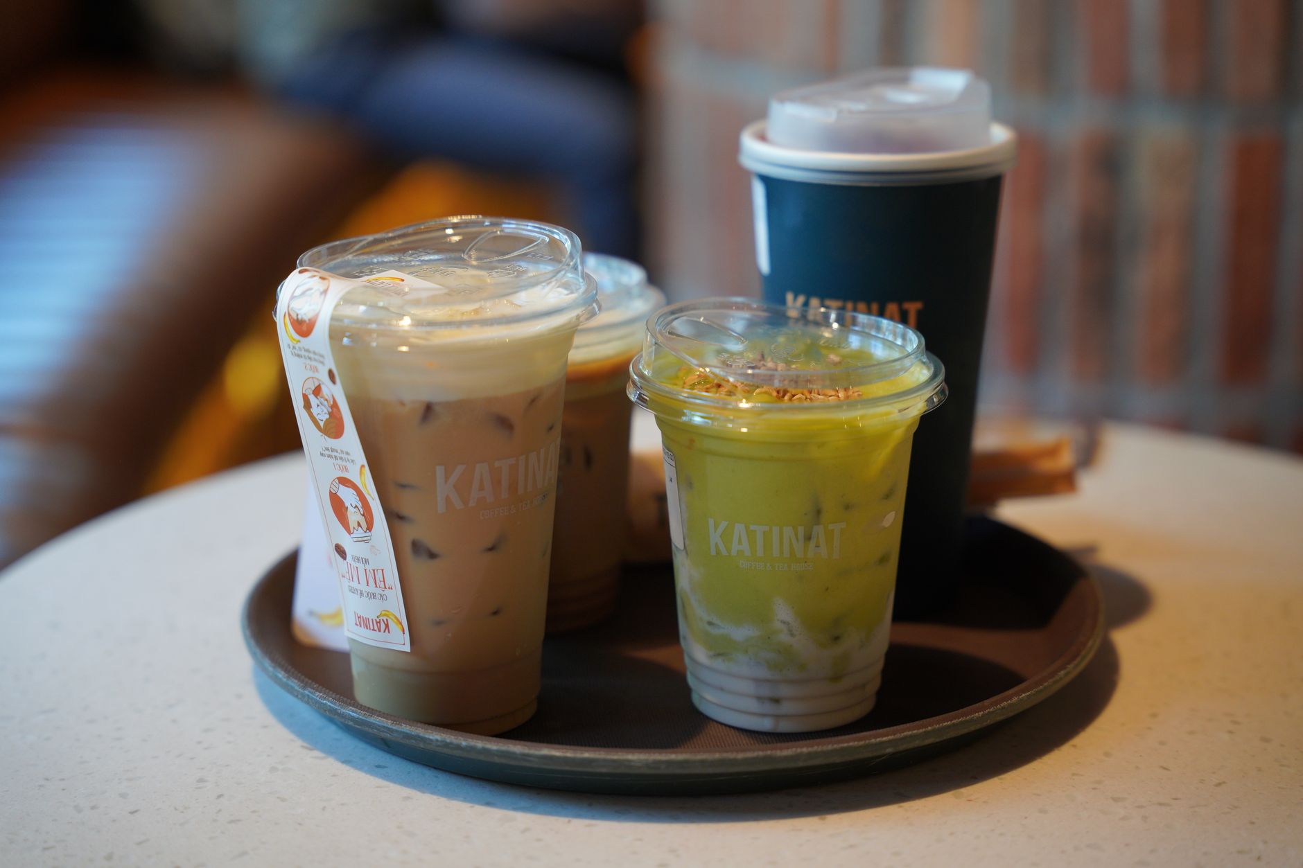 Iced matcha beverage with milk in a clear cup