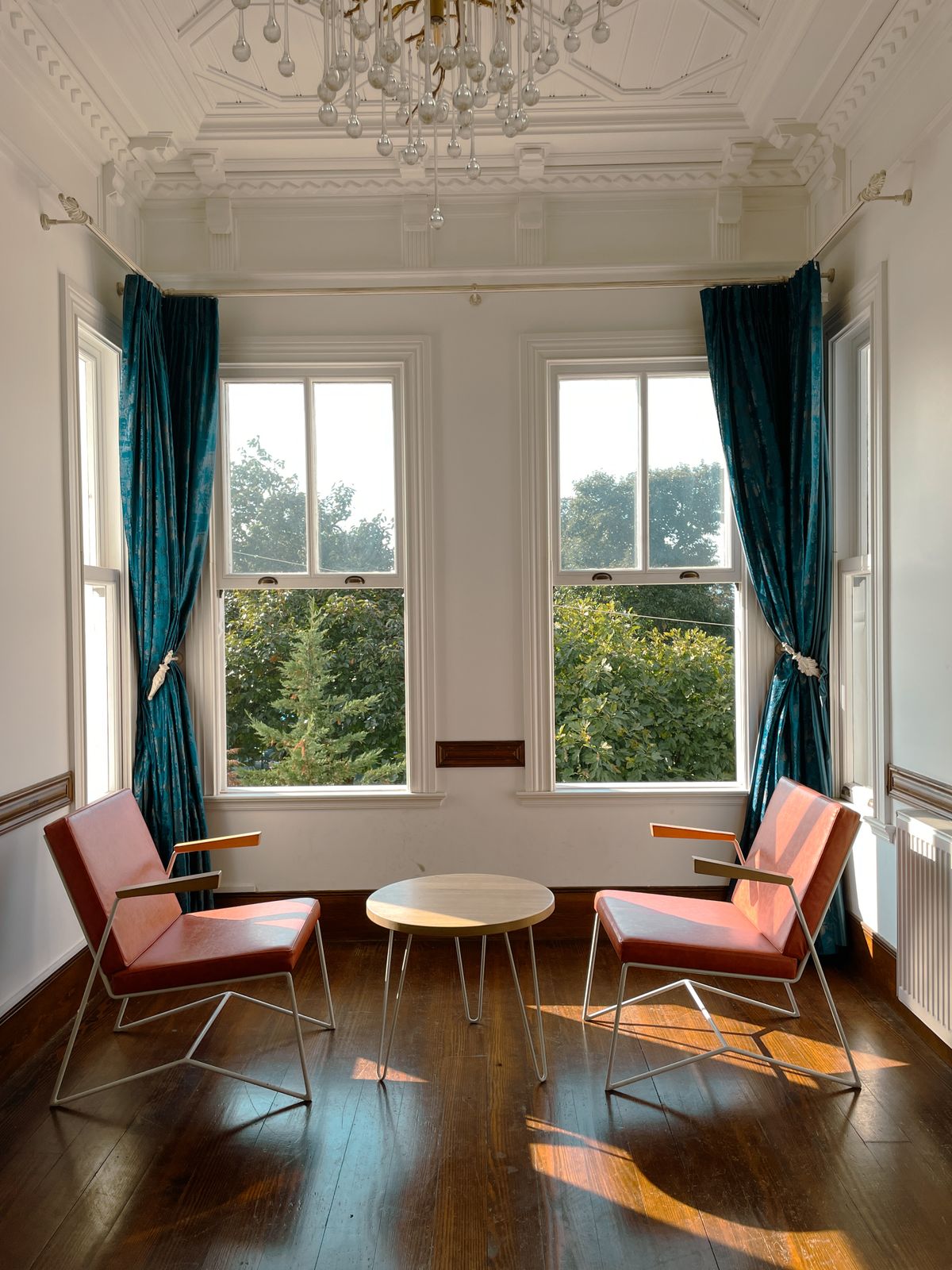 Window seat built around a radiator with a vented front panel