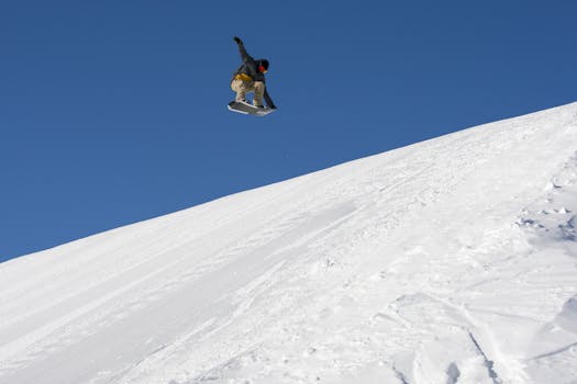 Snowboarder mid-air in Livigno, Italy. Capturing winter sports excitement.