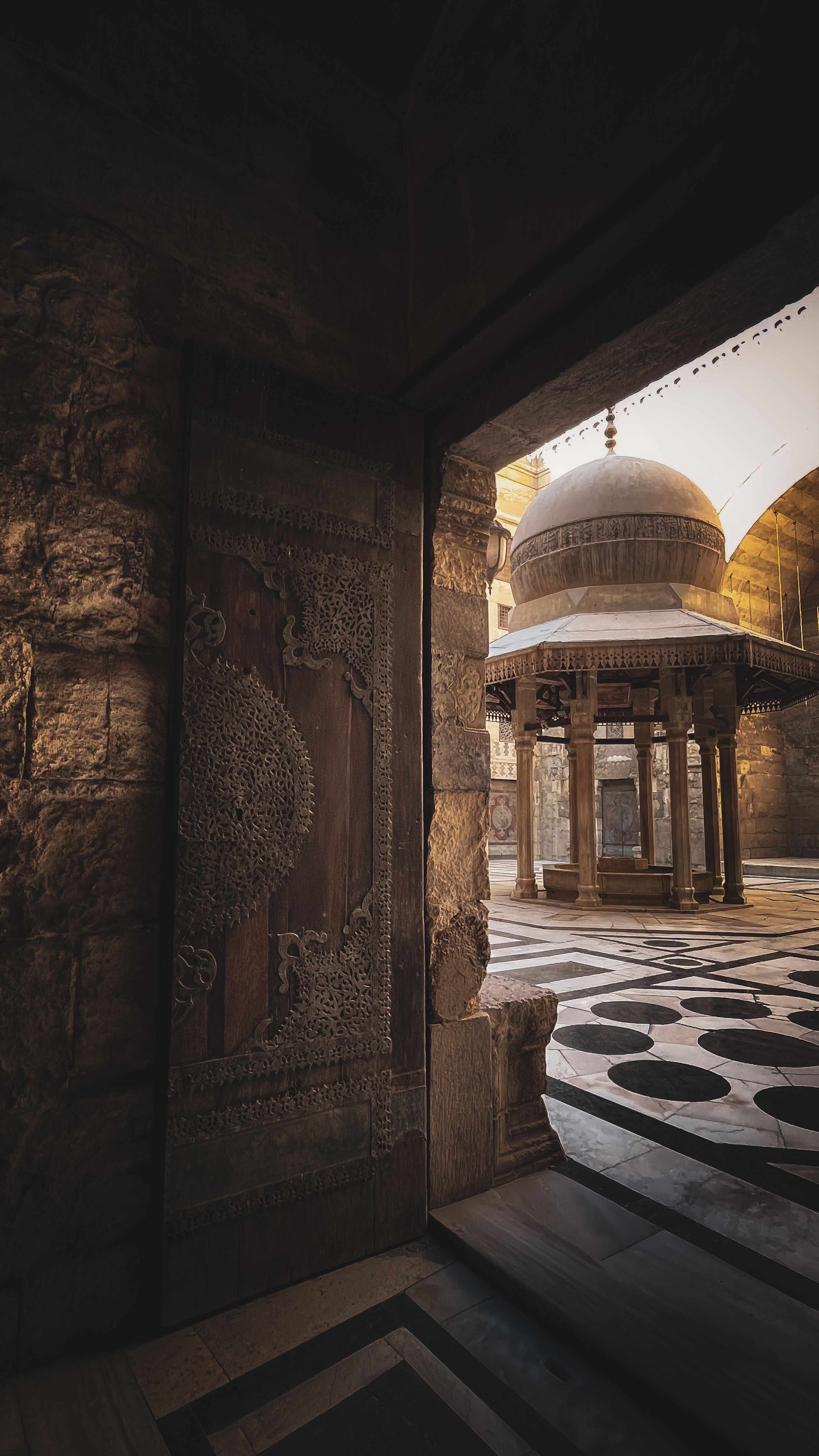 Stunning view of Islamic architecture featuring a dome and ornate decorations, lit by soft lighting.