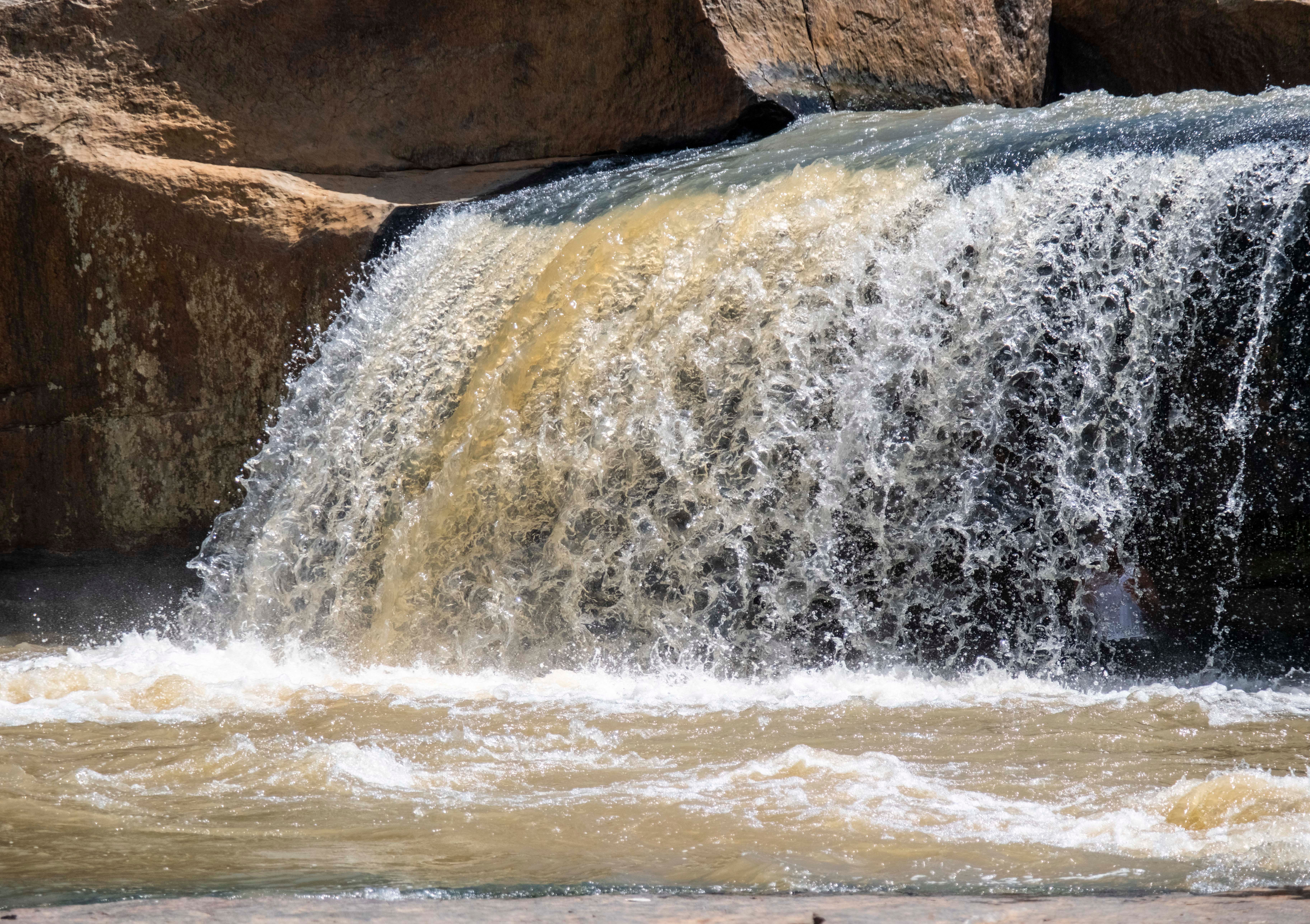 Beautiful waterfall cascading over rocks in Sebakapur, Odisha, India, creating a serene natural landscape.