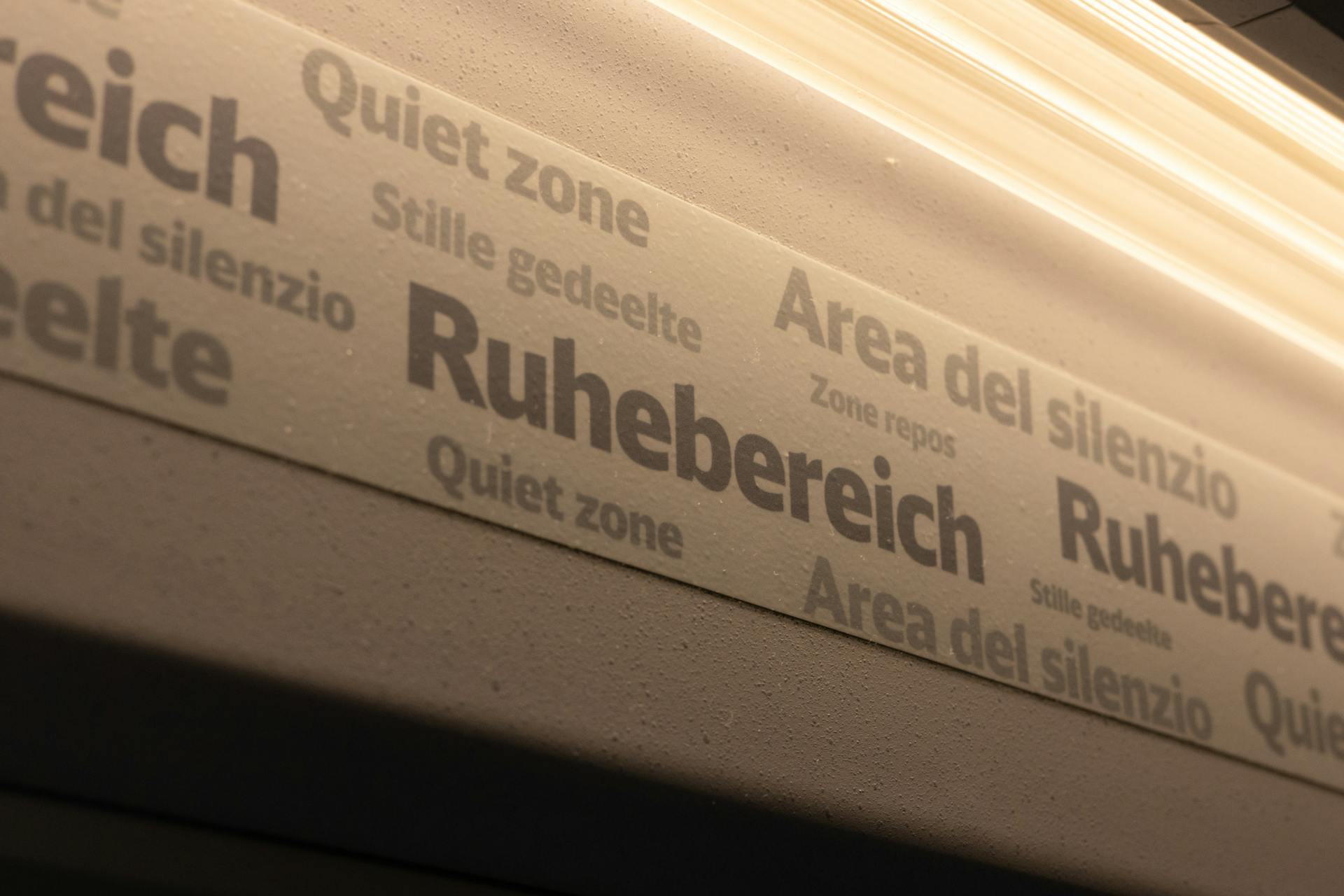 Multiple languages for quiet zone signs inside a train. Ideal for travel and commuting concepts.