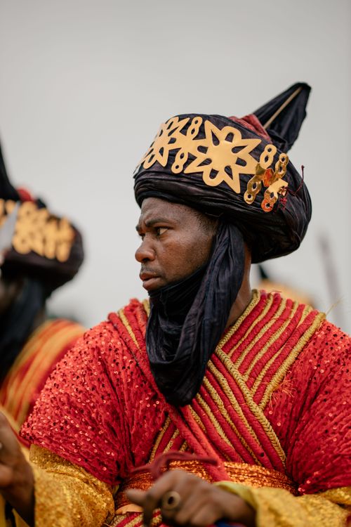 Free Man in vibrant traditional attire showcasing African cultural heritage. Stock Photo