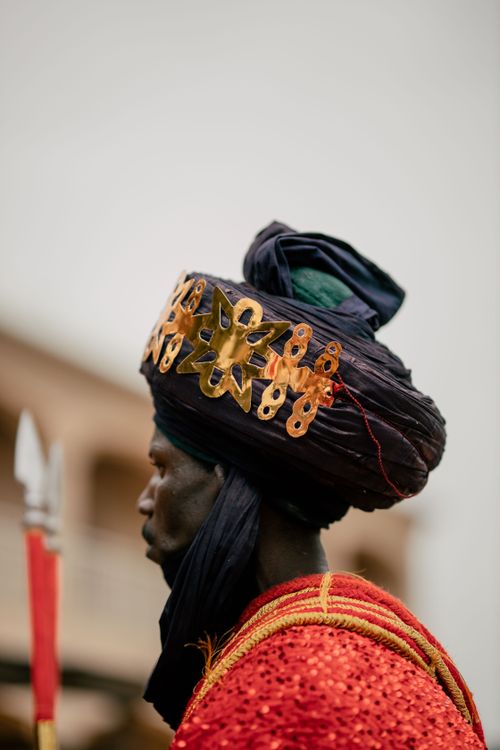 Free Profile of an African warrior in ceremonial dress with an ornate headdress. Stock Photo