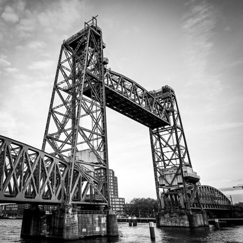 Free Impressive black and white photo of a historic steel lift bridge over water, showcasing architectural details. Stock Photo