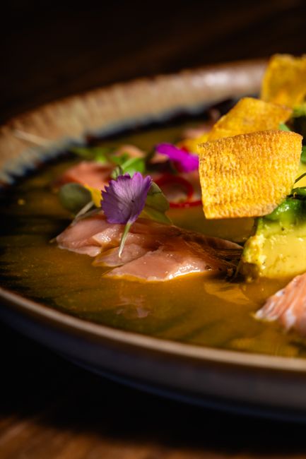 Exquisite gourmet ceviche dish with fish and vibrant garnishes