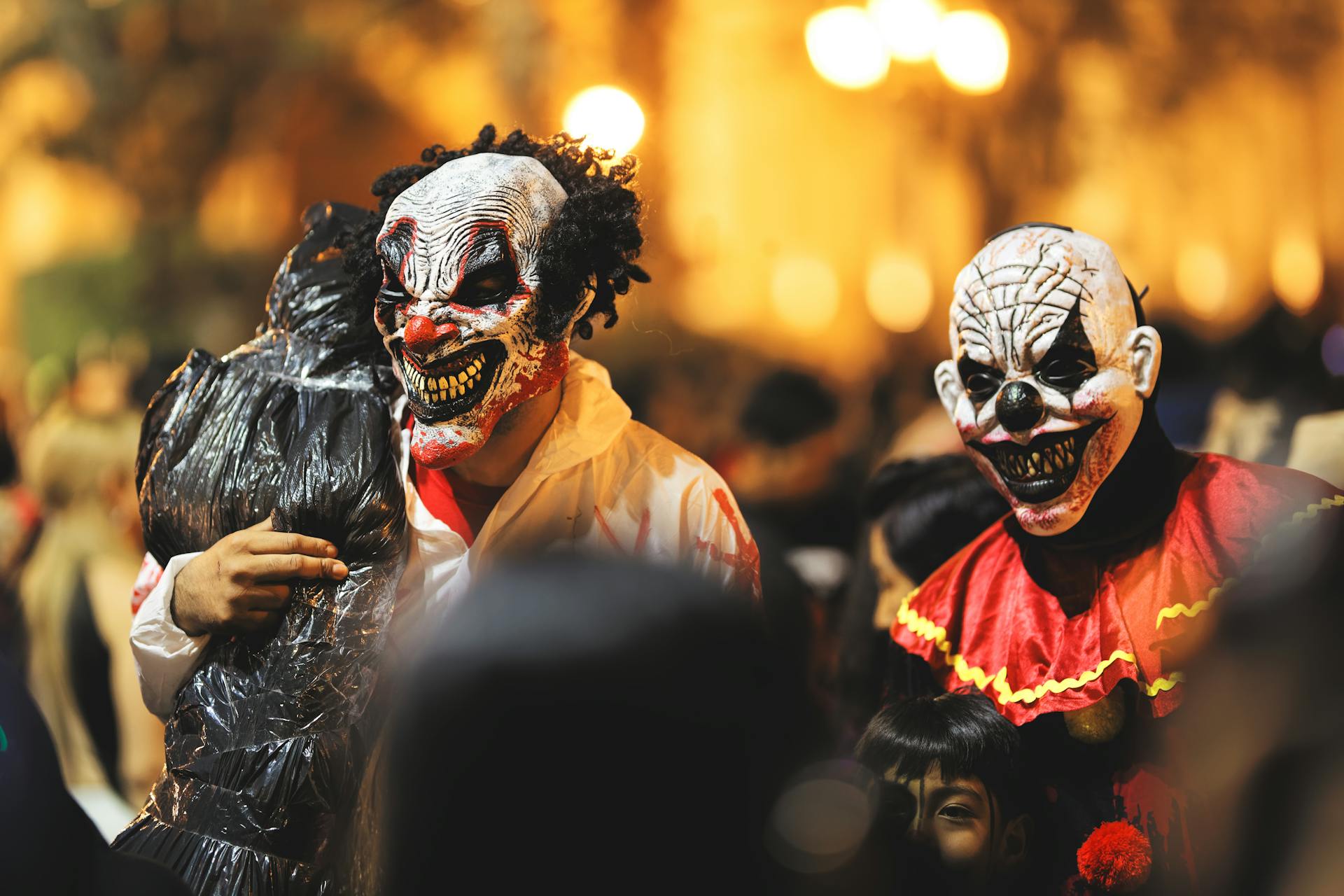 Spooky clowns in a Halloween parade in Arequipa, Peru, celebrating the holiday with eerie costumes.