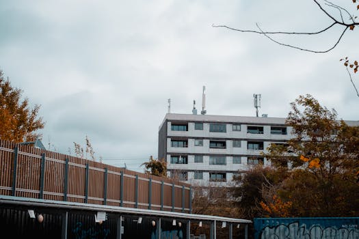 Modern building in Copenhagen surrounded by trees and overcast skies.