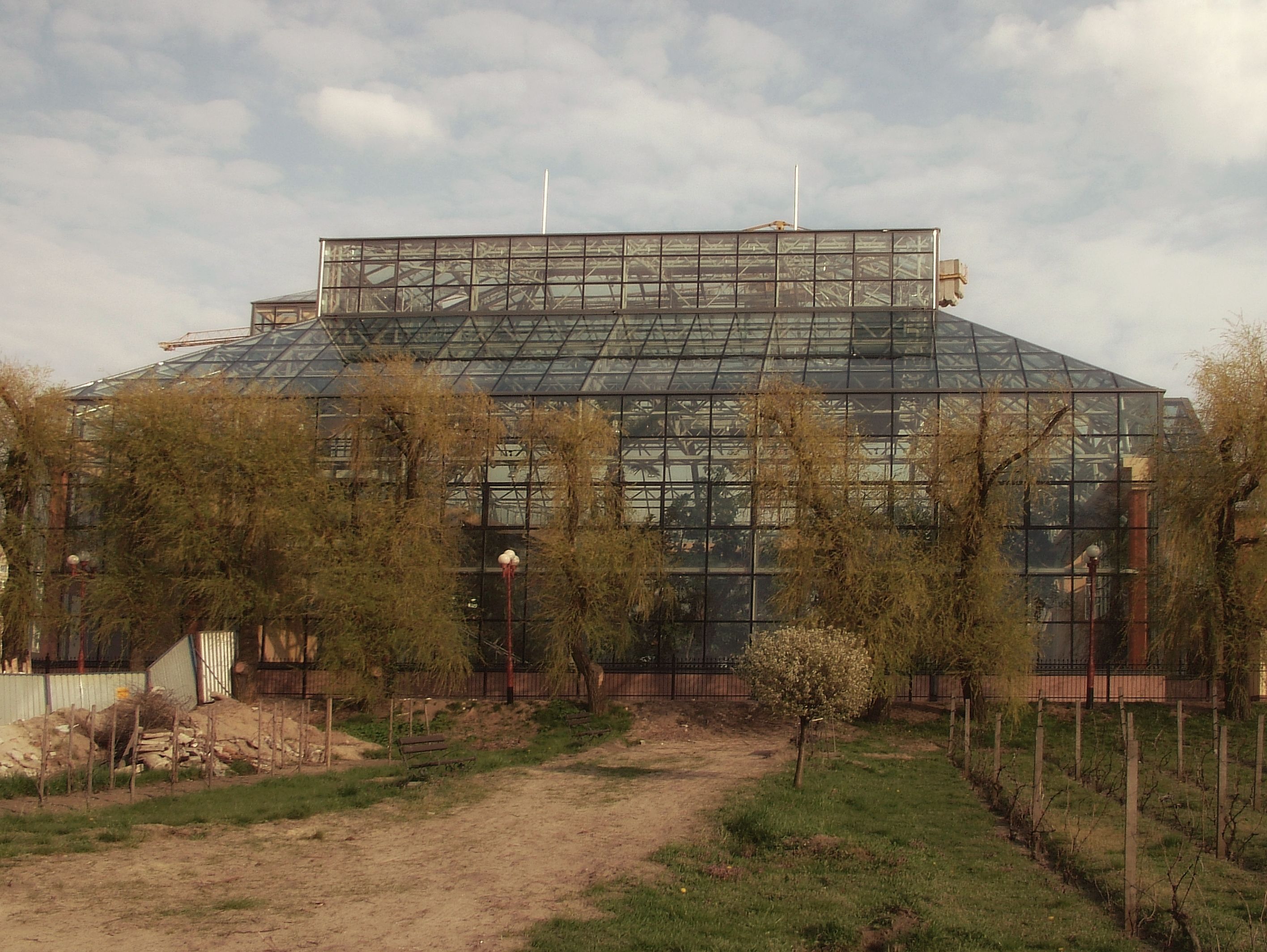 Large Glass Greenhouse with Trees in Springtime · Free Stock Photo