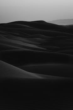 Monochrome image of serene sand dunes creating a dramatic landscape in California.