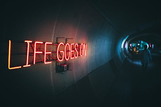A neon sign in a tunnel in Seoul reads 'Life Goes On', capturing a futuristic vibe.
