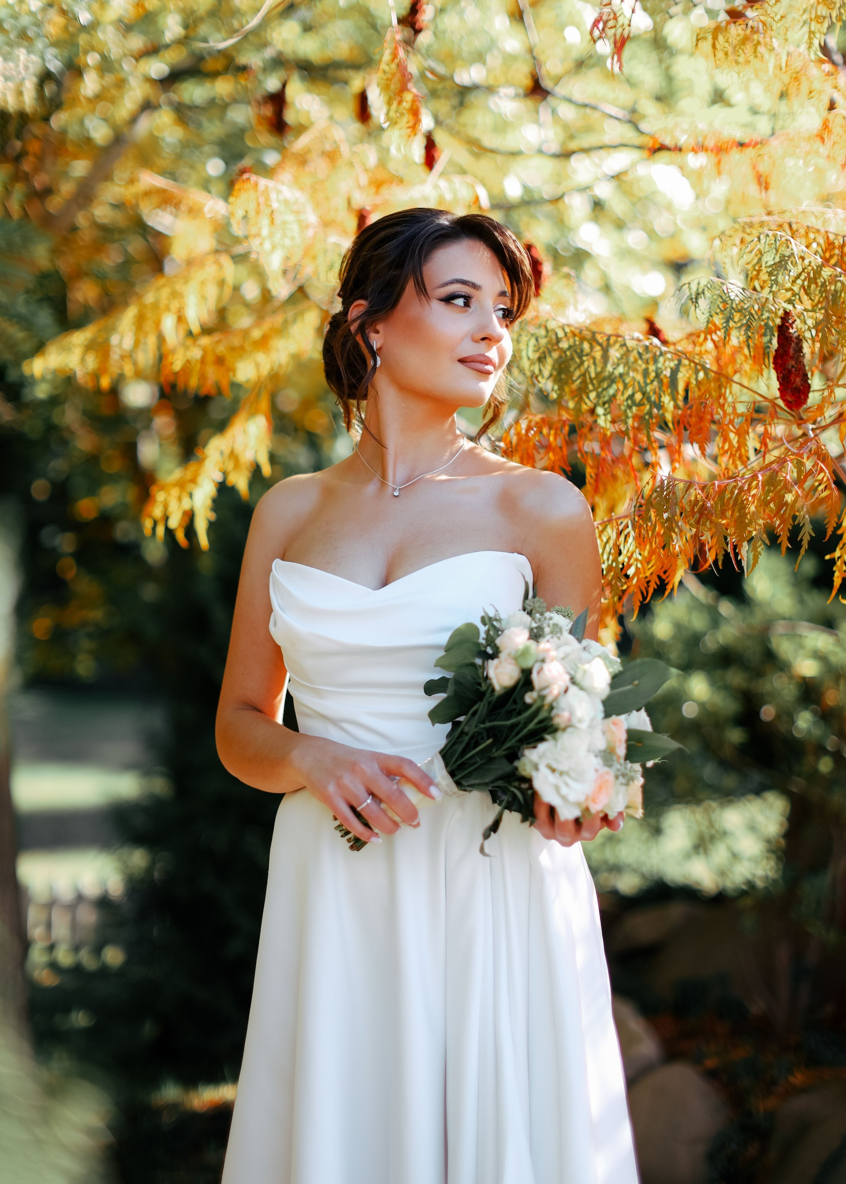 Elegant Bride in Autumn Garden Holding Bouquet  Free Stock Photo