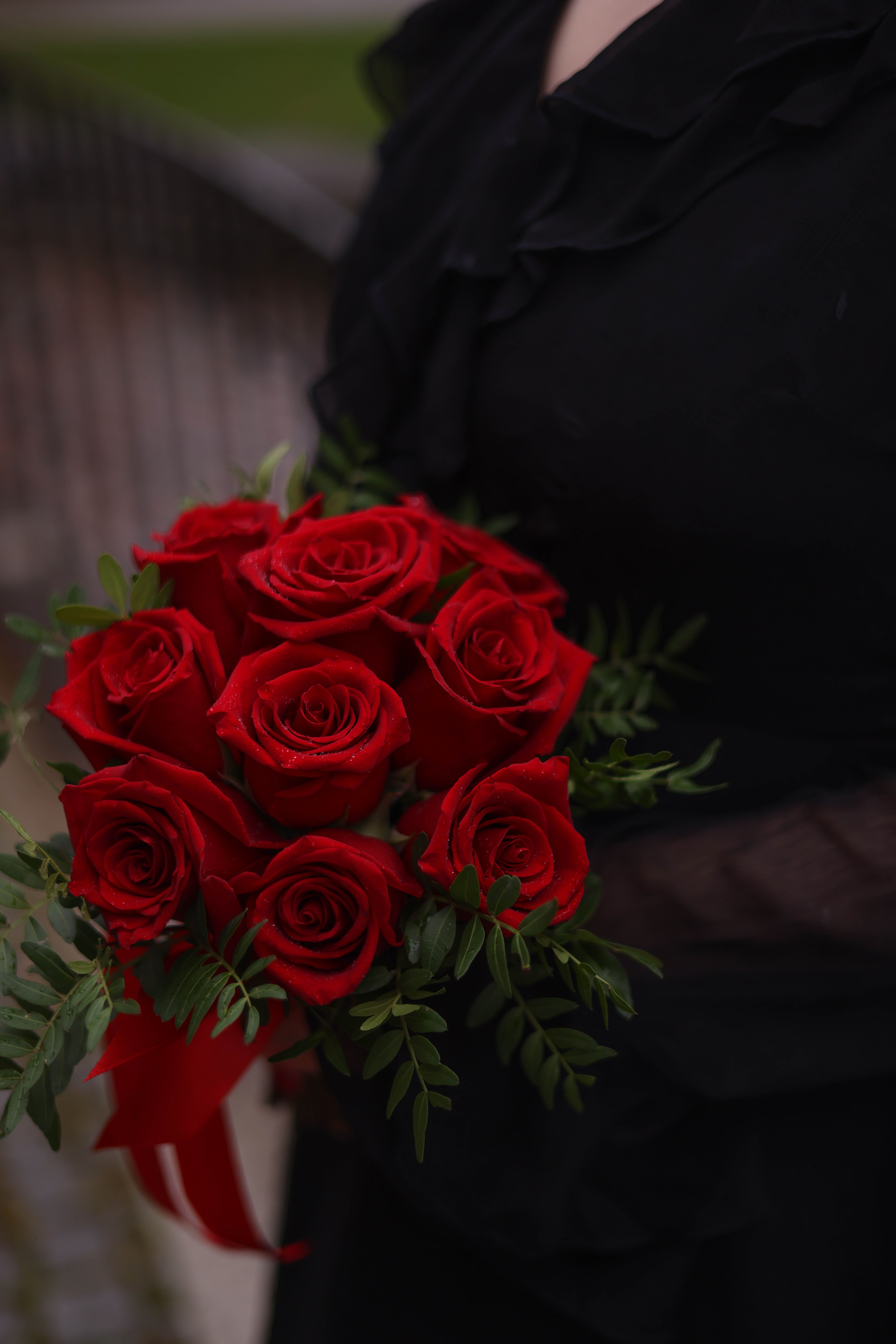 Elegant Bouquet of Red Roses Held by Woman · Free Stock Photo
