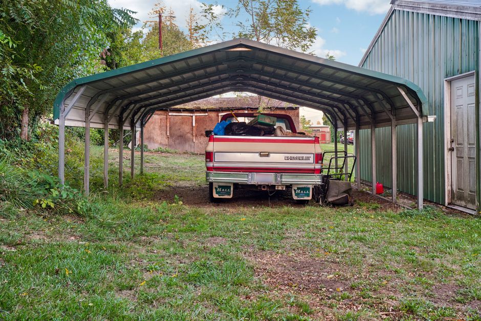 metal lean-to carport protecting a vehicle metal lean-to carport protecting a vehicle